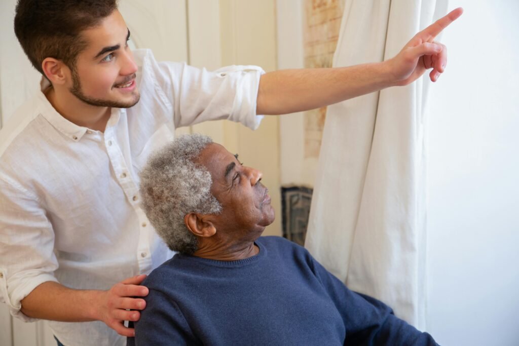 Professional caregiver assisting an elderly man at home